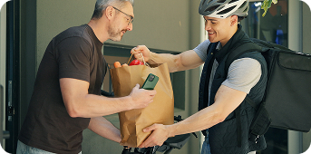 Shopper receiving a grocery delivery at the door